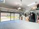 Spacious garage with overhead racks, storage shelves, and a clean, well-maintained floor at 3601 Mount Hope Loop, Leesburg, FL 34748