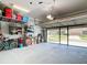 Spacious garage with overhead racks, storage shelves, and a clean, well-maintained floor at 3601 Mount Hope Loop, Leesburg, FL 34748