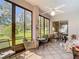 Relaxing lanai with tiled flooring, ceiling fan, and large windows showcasing a beautiful view at 3601 Mount Hope Loop, Leesburg, FL 34748