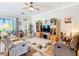 Cozy living room with neutral tones, ceiling fan, and wood-look flooring for a comfortable atmosphere at 3601 Mount Hope Loop, Leesburg, FL 34748