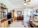 Bright living room featuring a ceiling fan, open floor plan, and seamless transitions to other living spaces at 3601 Mount Hope Loop, Leesburg, FL 34748