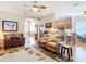 Spacious living room with open floor plan, ceiling fan and access to the kitchen and other living areas at 3601 Mount Hope Loop, Leesburg, FL 34748