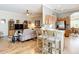 Open-concept living space seamlessly connects the living room, kitchen, and breakfast bar at 3601 Mount Hope Loop, Leesburg, FL 34748
