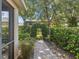 Landscaped backyard features a lovely brick path with an archway made of manicured bushes at 3677 Serena Ln, Clermont, FL 34711