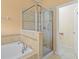 Bathroom showcases a glass shower enclosure and a relaxing soaking tub with tile surround at 3677 Serena Ln, Clermont, FL 34711