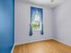 Bedroom featuring wood-look flooring, bright walls and a bright window with patterned curtains at 3677 Serena Ln, Clermont, FL 34711