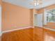 Bright bedroom with gleaming hardwood floors, a ceiling fan, ensuite bathroom and natural light at 3677 Serena Ln, Clermont, FL 34711