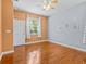 Bedroom features hardwood floors, ceiling fan, and a bright window overlooking the yard at 3677 Serena Ln, Clermont, FL 34711