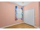 Bedroom featuring wood-look flooring, window with curtains and a double closet with white doors at 3677 Serena Ln, Clermont, FL 34711