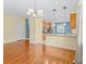 Open-concept dining room and kitchen with hardwood floors at 3677 Serena Ln, Clermont, FL 34711