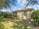 Well-maintained home exterior featuring lush lawn, landscaping, and an efficient HVAC system at 3677 Serena Ln, Clermont, FL 34711