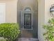 The home features a screened front door with a beveled window and a matching arched window above at 3677 Serena Ln, Clermont, FL 34711
