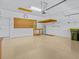 Spacious garage features ample storage, work area, and epoxy flooring at 3677 Serena Ln, Clermont, FL 34711