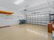 Garage featuring an automatic door, lots of space for parking and storage, and epoxy flooring at 3677 Serena Ln, Clermont, FL 34711