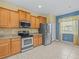 Bright kitchen featuring stainless steel appliances and ample cabinet space at 3677 Serena Ln, Clermont, FL 34711