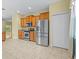 Kitchen area with stainless steel appliances, cabinets, and tile floors at 3677 Serena Ln, Clermont, FL 34711
