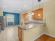 Open kitchen with granite countertops and stainless steel appliances at 3677 Serena Ln, Clermont, FL 34711