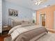 Cozy bedroom featuring a luxurious bed, wood floors, and neutral decor at 3677 Serena Ln, Clermont, FL 34711