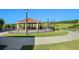 A covered gazebo is furnished with tables and chairs for community residents to gather at 3677 Serena Ln, Clermont, FL 34711