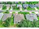Aerial view of a well-maintained home and neighborhood with mature trees and landscaping at 3681 Arlington Ridge Blvd, Leesburg, FL 34748