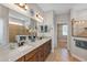 Bathroom with double sink vanity with cabinet storage and walk-in shower at 3681 Arlington Ridge Blvd, Leesburg, FL 34748
