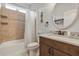 Bathroom with a single sink, toilet, shower-tub combo, and a large mirror at 3681 Arlington Ridge Blvd, Leesburg, FL 34748