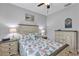Bedroom with bed, dresser, and nightstand with decorative lamps at 3681 Arlington Ridge Blvd, Leesburg, FL 34748