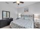 Bedroom with bed, dresser, and nightstand with decorative lamps at 3681 Arlington Ridge Blvd, Leesburg, FL 34748