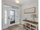 Inviting foyer with decorative glass door and stylish console table creates a warm entrance at 3681 Arlington Ridge Blvd, Leesburg, FL 34748