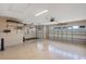 Spacious two-car garage with epoxy floor, overhead doors, shelving and ample storage space at 3681 Arlington Ridge Blvd, Leesburg, FL 34748