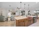 Open-concept kitchen with a copper farmhouse sink, island seating, and views into the light-filled living area at 3681 Arlington Ridge Blvd, Leesburg, FL 34748