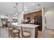 Spacious kitchen with a large island and barstool seating, stainless steel appliances, and warm wood cabinetry at 3681 Arlington Ridge Blvd, Leesburg, FL 34748