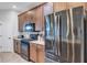 Kitchen area with modern stainless steel refrigerator and appliances, and plentiful counter space at 3681 Arlington Ridge Blvd, Leesburg, FL 34748