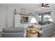 Comfortable living room area with TV and sliding door access to screened-in lanai at 3681 Arlington Ridge Blvd, Leesburg, FL 34748
