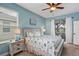 Serene main bedroom with a ceiling fan, lots of light, and a sliding glass door to the outdoor patio at 3681 Arlington Ridge Blvd, Leesburg, FL 34748