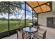 Screened in patio with table and chairs overlooking green space at 3681 Arlington Ridge Blvd, Leesburg, FL 34748