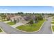 Aerial view of a home in a lakeside community with mature landscaping and a three-car garage at 3750 Raspberry Ct, The Villages, FL 32163