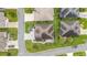 Detailed aerial view of a home with pristine landscaping and a stone patio, nestled in a well-kept neighborhood at 3750 Raspberry Ct, The Villages, FL 32163