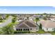 High-angle aerial view of a neighborhood showcasing homes with screened patios, landscaping, and well-maintained lawns at 3750 Raspberry Ct, The Villages, FL 32163