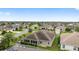 Overhead aerial view of a residential neighborhood with homes surrounded by lush greenery and palm trees, creating a serene environment at 3750 Raspberry Ct, The Villages, FL 32163