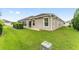 Backyard with a covered lanai, lush grass, and manicured landscaping at 3750 Raspberry Ct, The Villages, FL 32163
