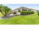 Well maintained backyard featuring a patio area with table and chairs and manicured landscaping at 3750 Raspberry Ct, The Villages, FL 32163