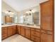 Bathroom featuring double sinks, granite countertops, a storage cabinet and tiled floors at 3750 Raspberry Ct, The Villages, FL 32163
