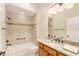 Bright bathroom with a tiled shower-tub combination, complete with granite vanity and modern fixtures at 3750 Raspberry Ct, The Villages, FL 32163