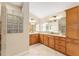 Bathroom featuring double sinks, granite countertops and tiled floors at 3750 Raspberry Ct, The Villages, FL 32163