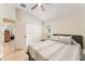 Neutral bedroom featuring a ceiling fan, closet and a comfortable bed with striped linens at 3750 Raspberry Ct, The Villages, FL 32163