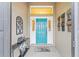 Welcoming entryway with a vibrant blue front door and decorative accents at 3750 Raspberry Ct, The Villages, FL 32163