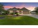 Charming one-story home featuring a well-maintained lawn, mature landscaping, and a spacious three-car garage at 3750 Raspberry Ct, The Villages, FL 32163