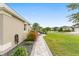 Landscaped walkway and beautiful plantings on the side of the home at 3750 Raspberry Ct, The Villages, FL 32163