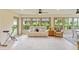 Light-filled Florida room featuring large windows and comfortable seating at 3750 Raspberry Ct, The Villages, FL 32163